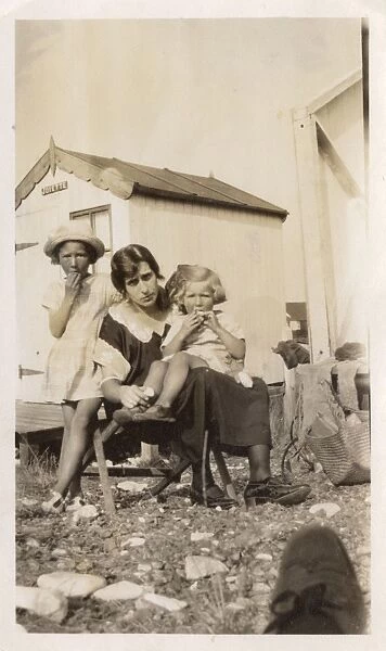 Mother and two daughters having lunch near their beach hut