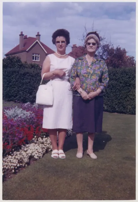 Framed Print : Mother and Grandmother in a neat suburban back garden Framed Print : Mother and Grandmother in a neat suburban back garden