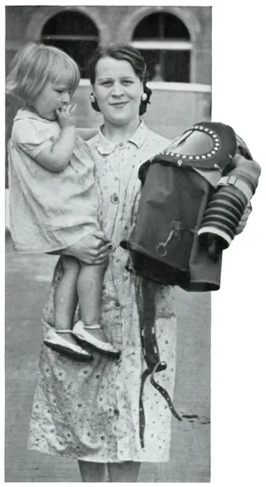 Framed Print : Mother holding baby and specialised gas mask, Sept 1939 Framed Print : Mother holding baby and specialised gas mask, Sept 1939