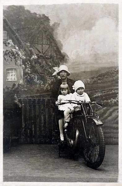 Mother and her two young children - studio photo on bike