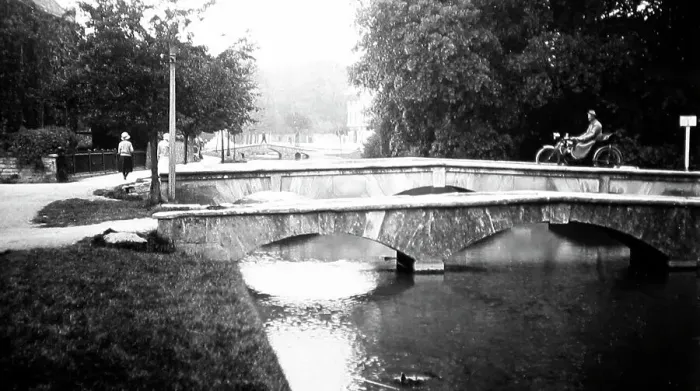 Framed Print : Motorcyclist on a bridge in Bourton on the Water Framed Print : Motorcyclist on a bridge in Bourton on the Water