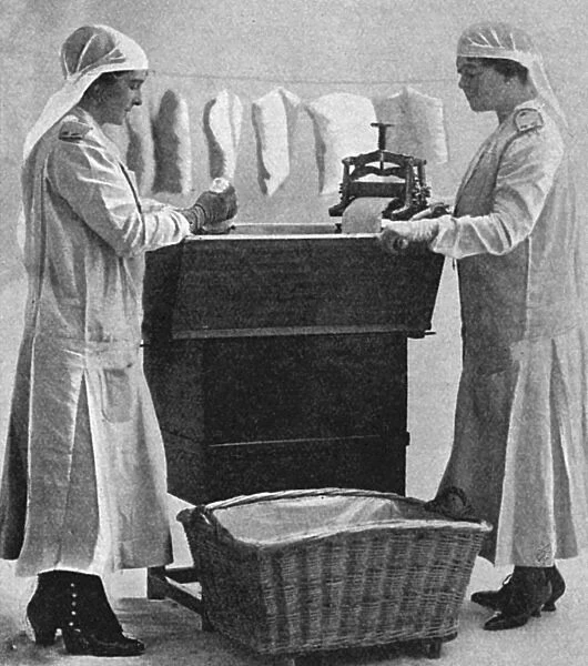 Mrs Lawrence & Mrs Mason carbonising garments for troops, WW1