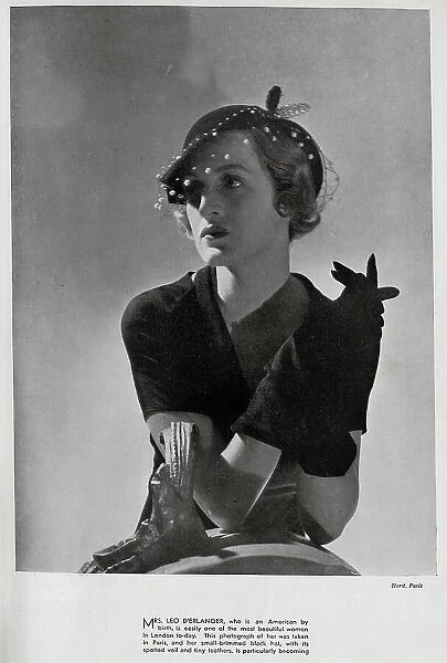 Mrs Leo d'Erlanger, studio fashion portrait in hat and gloves. With description, Mrs Leo d'Erlanger, who is an American by birth, is easily one of the most beautiful women in London to-day