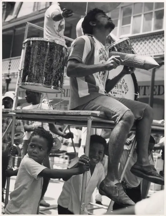 Framed Print : A musician sits on a float in an ecstatic trance, really into the music, while a couple of children sit beneath him at the Port of Spain Carnival, Trinidad, W. Indies. Date: 1968 Framed Print : A musician sits on a float in an ecstatic trance, really into the music, while a couple of children sit beneath him at the Port of Spain Carnival, Trinidad, W. Indies. Date: 1968
