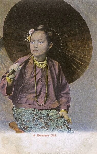 Myanmar - A Burmese girl with large open paper parasol