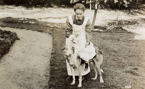 Nanny taking baby for a ride on a large dog