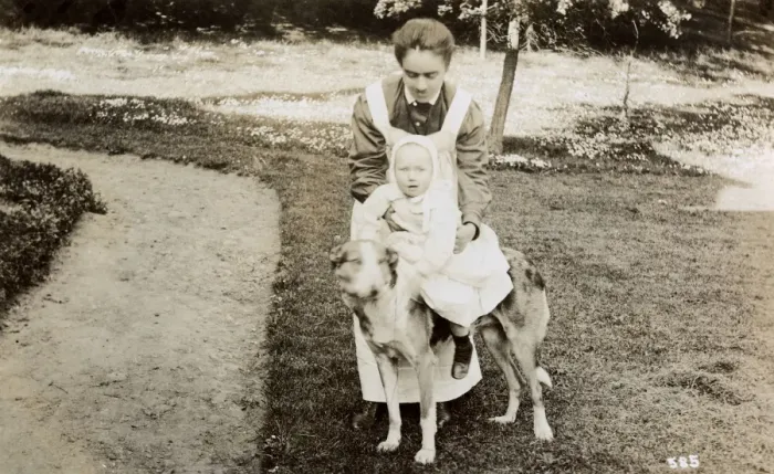 Framed Print : Nanny taking baby for a ride on a large dog Framed Print : Nanny taking baby for a ride on a large dog