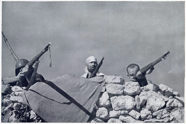 Some Nationalist irregular troops firing at a Republican position near Huesca, during the Spanish Civil War. Date: 1936