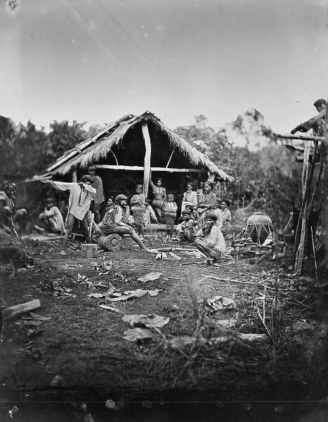 Natives grouped in front of a hut, Manila, Luzon, Philippine