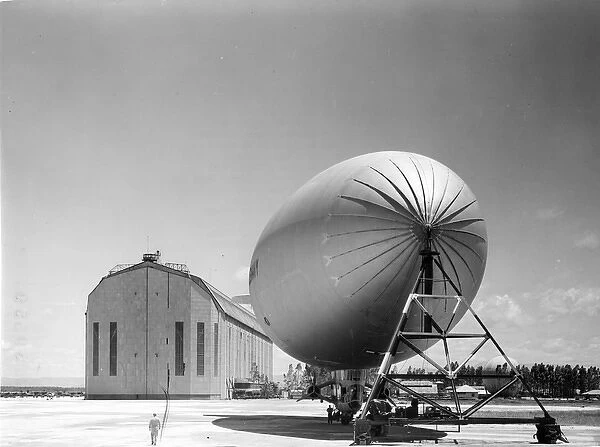 US Navy Goodyear K-Series airship alongside a hangar