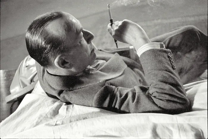 Framed Print : Noel Coward sits with cigarette in holder during rehearsal of Relative Values which opened at The Savoy Theatre in November 1951 Date: 1951 Framed Print : Noel Coward sits with cigarette in holder during rehearsal of Relative Values which opened at The Savoy Theatre in November 1951 Date: 1951
