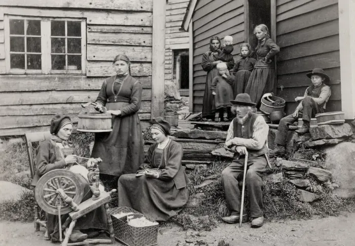 Framed Print : Norway, rural family outside home with spinning wheel