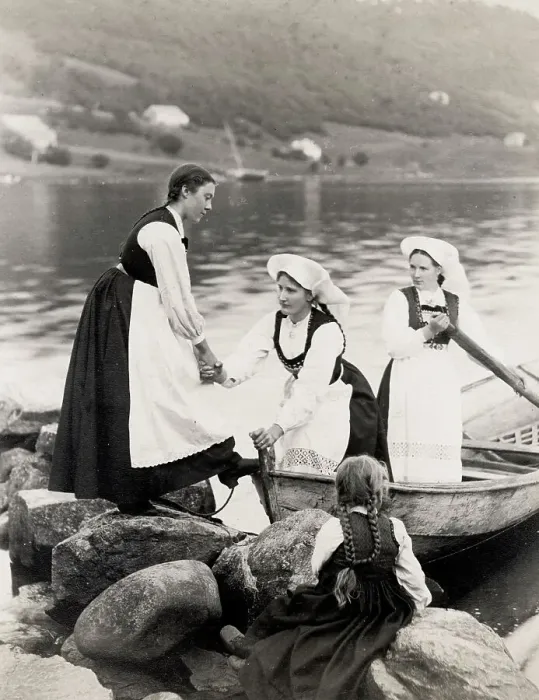 Framed Print : Norwegian woman traditional dress climbing out of boat Framed Print : Norwegian woman traditional dress climbing out of boat