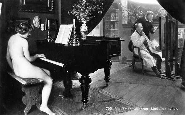 Nude model on a break plays a piano