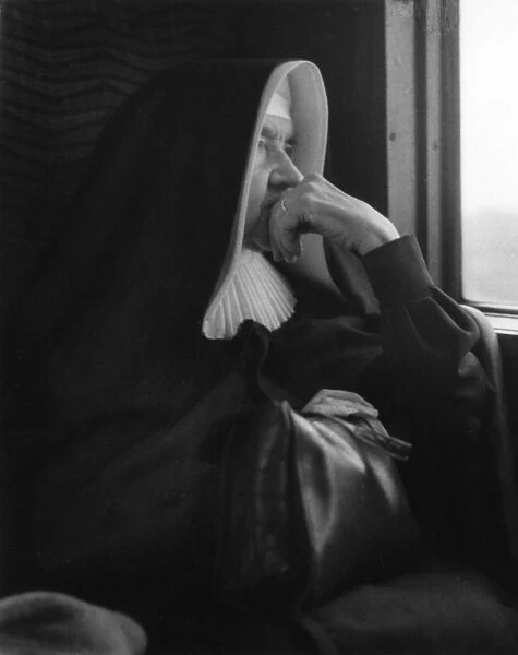 Nun sitting by a window