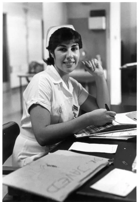 Framed Print : Nurse seated at desk Framed Print : Nurse seated at desk