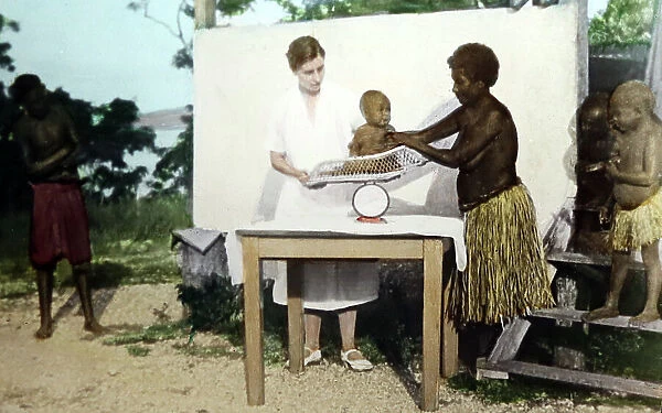 Nurse weighing a baby, Christian Missionary, Port Moresby