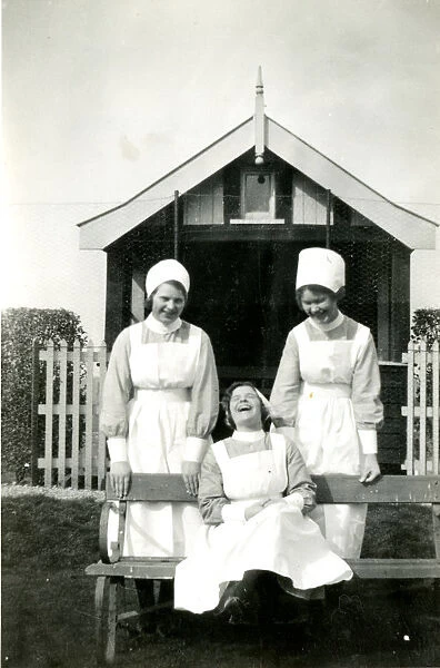 Three nurses in a garden