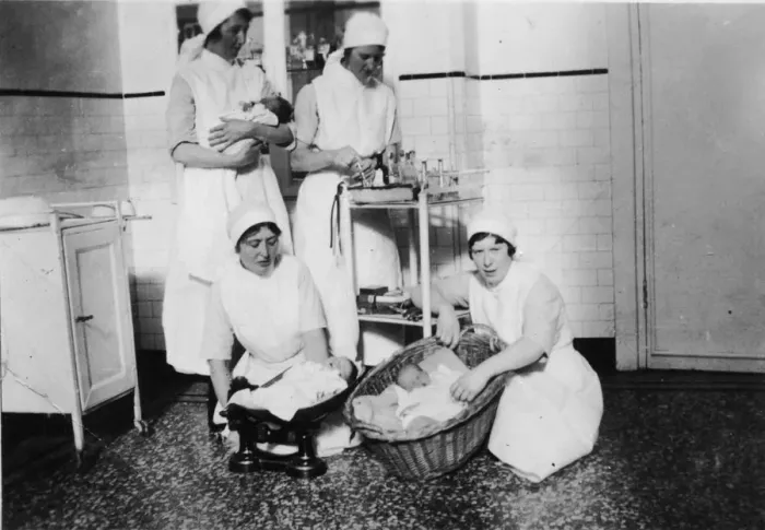 Framed Print : Nurses weighing babies Framed Print : Nurses weighing babies