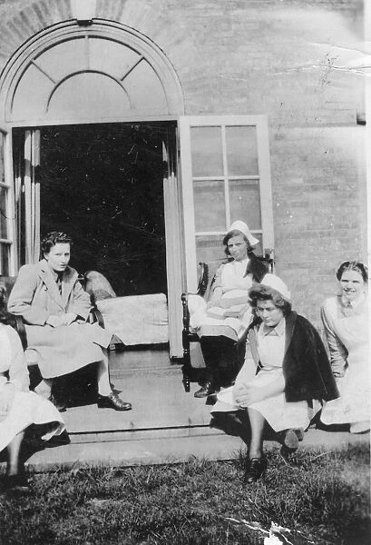 Four nurses and woman in on steps