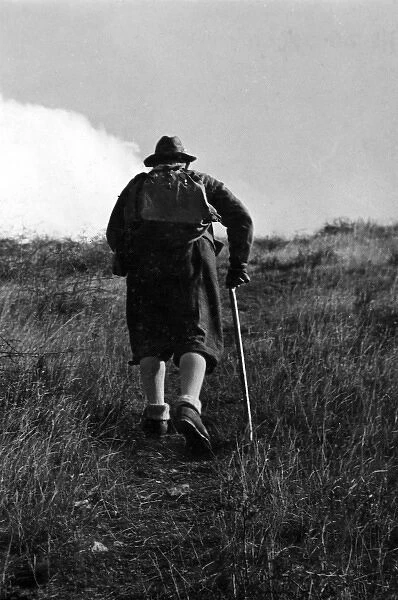 OLD HIKER. An old man takes to the hills for a healthy hike! Date: 1930s