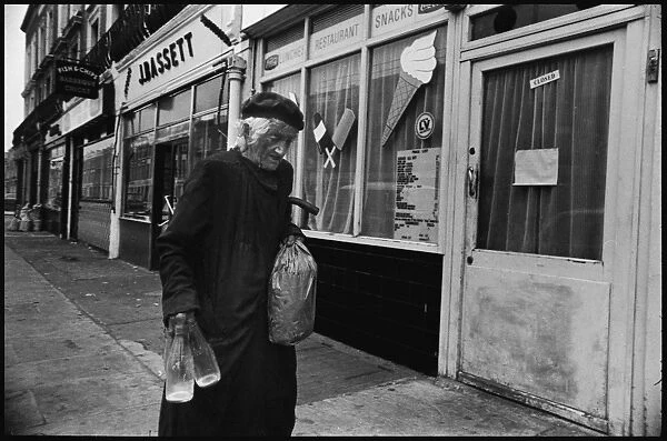 Old lady with milk bottles Notting Hill London early