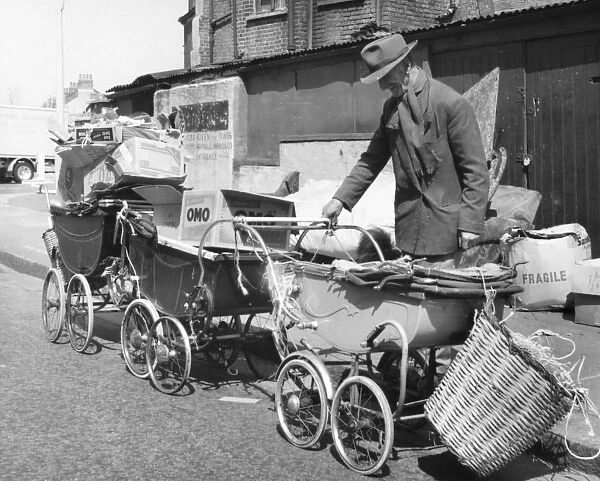 Old man with prams and junk, Balham, SW London