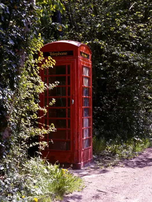 Framed Print : Old style telephone box in a quiet country village road Framed Print : Old style telephone box in a quiet country village road