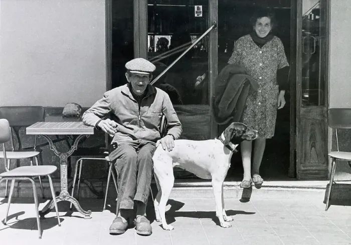 Framed Print : An older man with his pet dog seated at a small table on a terrace outside a cafe or restaurant in the south of France. Date: circa 1970s Framed Print : An older man with his pet dog seated at a small table on a terrace outside a cafe or restaurant in the south of France. Date: circa 1970s
