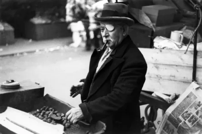 Framed Print : One-eyed man roasting chestnuts at market Framed Print : One-eyed man roasting chestnuts at market