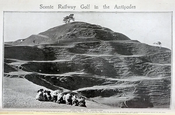 One-Tree Hill, Auckland, outdoor scenic photograph, with spectators in the foreground. Captioned, Scenic Railway Golf in the Antipodes, where an ingenious