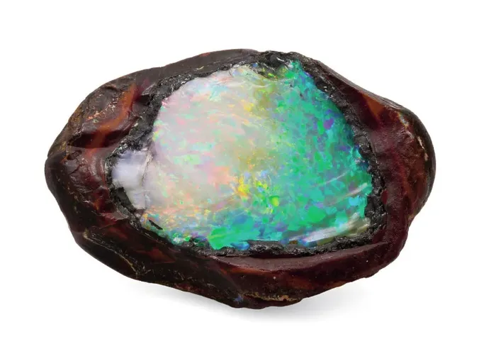 Framed Print : Opal in its natural form. The boulder has been split open to reveal the Framed Print : Opal in its natural form. The boulder has been split open to reveal the