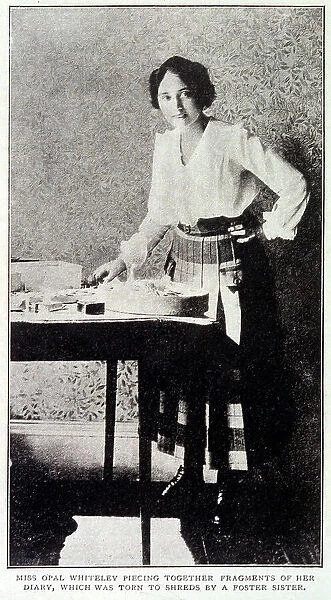 Opal Whiteley (1897 -1992), mysterious diarist, repairing her diary which was damaged by a foster sister Date: 1920