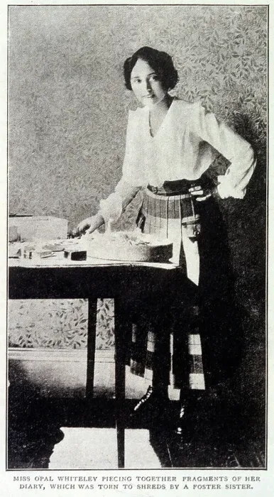 Framed Print : Opal Whiteley (1897 -1992), mysterious diarist, repairing her diary which was damaged by a foster sister Date: 1920 Framed Print : Opal Whiteley (1897 -1992), mysterious diarist, repairing her diary which was damaged by a foster sister Date: 1920