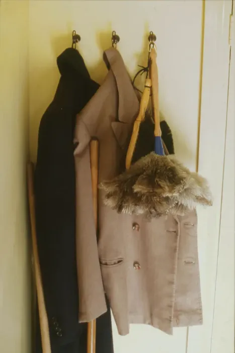Framed Print : Two overcoats and a feather duster, hanging from three hooks behind a bedroom door. Date: 1940s (re-enactment) Framed Print : Two overcoats and a feather duster, hanging from three hooks behind a bedroom door. Date: 1940s (re-enactment)