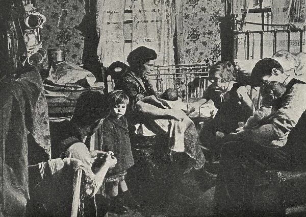 Overcrowded housing. A family of seven in their cramped single-room accommodation