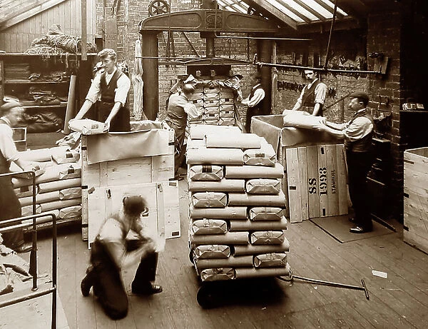 Packing finished cloth in a woollen mill in Bradford