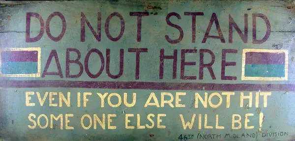 A painted wooden trench sign entitled DO NOT STAND ABOUT