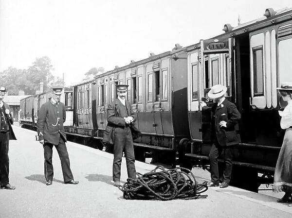 Passengers and porters at an English railway station
