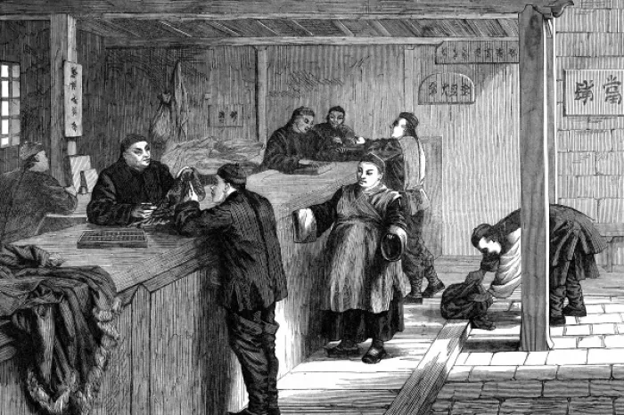 Framed Print : A pawnbroker in Shanghai does business with his customers Framed Print : A pawnbroker in Shanghai does business with his customers
