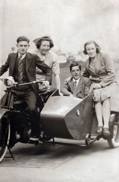 Four people on a 1927 Royal Enfield motorcycle & sidecar