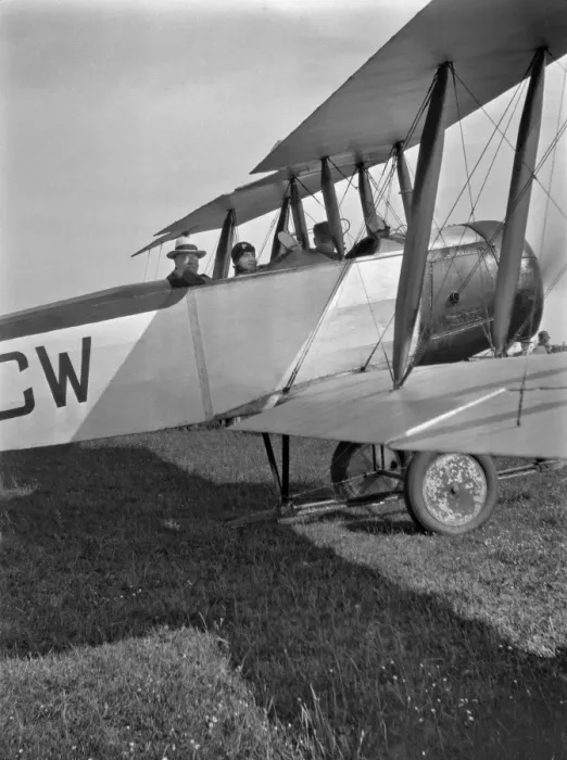Framed Print : Three people in a biplane on an airfield Framed Print : Three people in a biplane on an airfield