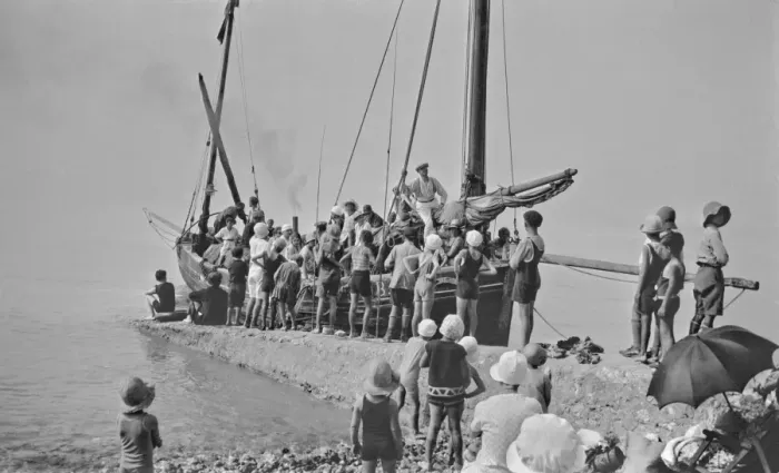 Framed Print : People on and around a boat by a jetty - France Framed Print : People on and around a boat by a jetty - France