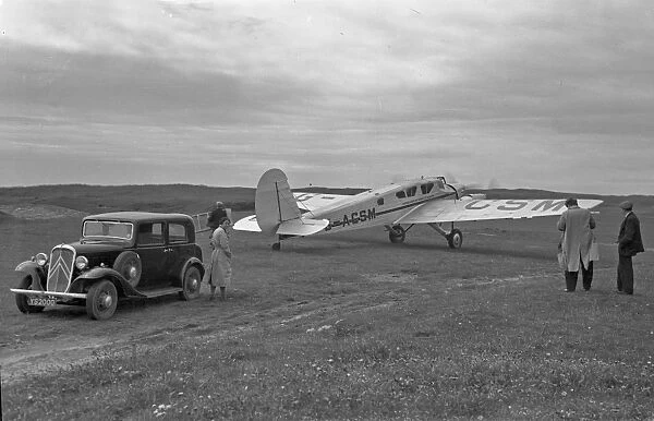 People with car and light aircraft, Scotland