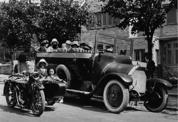 People in charabanc and motorcycle sidecar