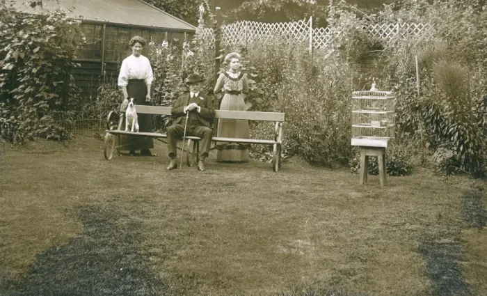 Framed Print : Three people with a dog in a garden Framed Print : Three people with a dog in a garden