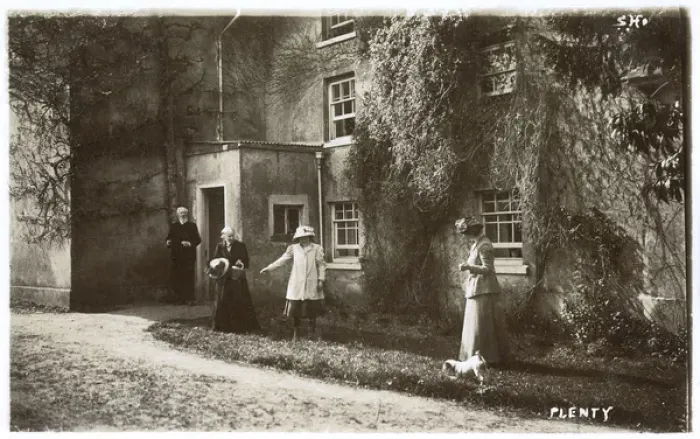 Framed Print : People and dog outside a large house Framed Print : People and dog outside a large house