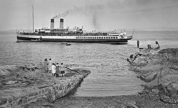 People on jetty watching a steamer