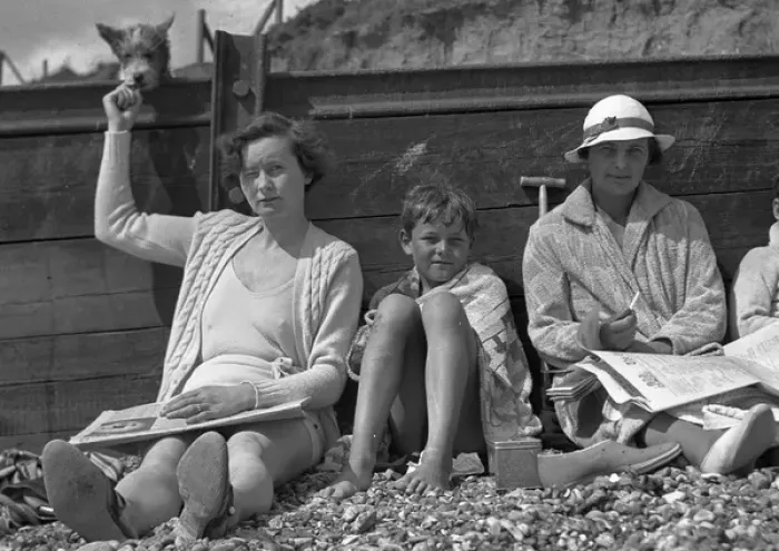 Framed Print : People leaning against a breaker on a beach Framed Print : People leaning against a breaker on a beach