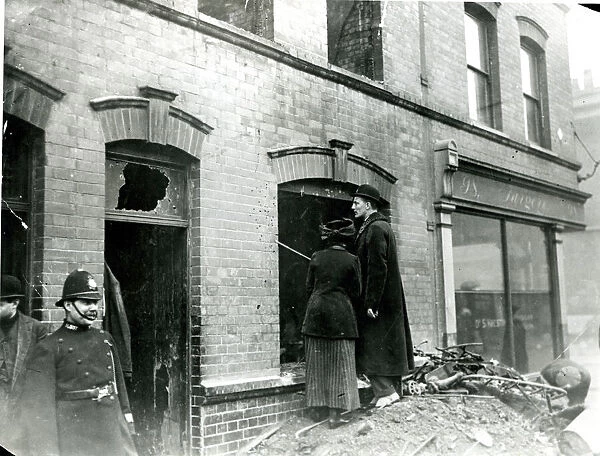 People looking at bullet holes after Sidney Street Siege